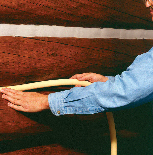 Step 4 Backer Rod applying back rod to synthetic chinking
